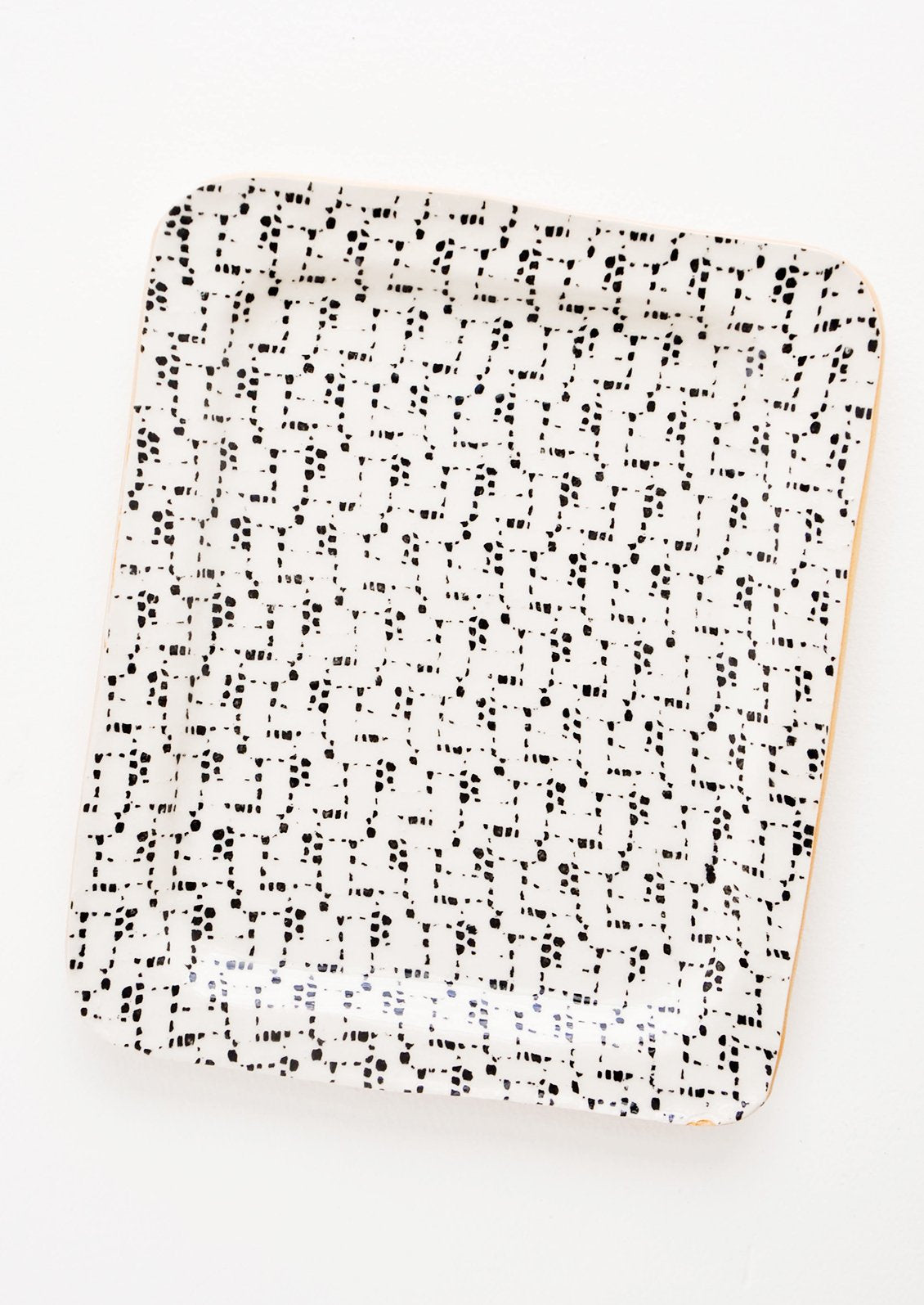 A rectangular ceramic tray with black and white patterned finish.