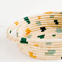 4: Woven raffia basket with handles at sides and colorful spots