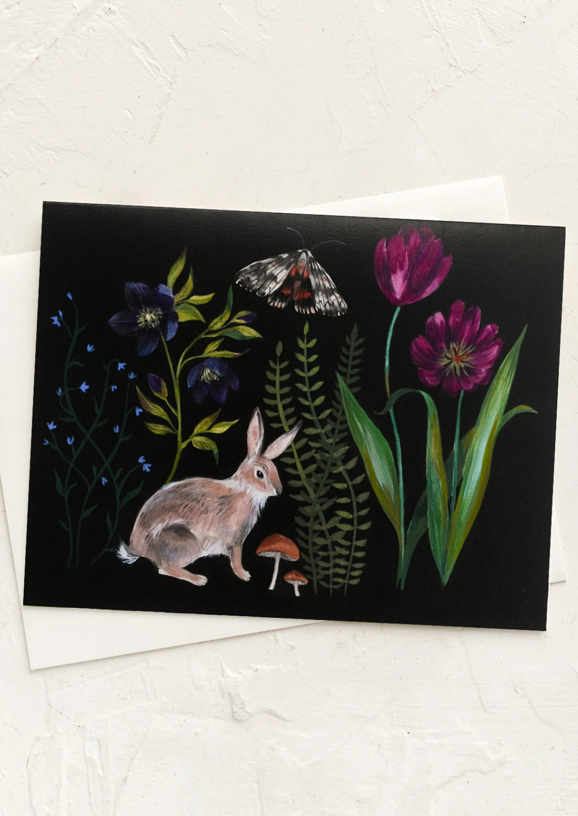An illustrated greeting card with flora and fauna on black background.