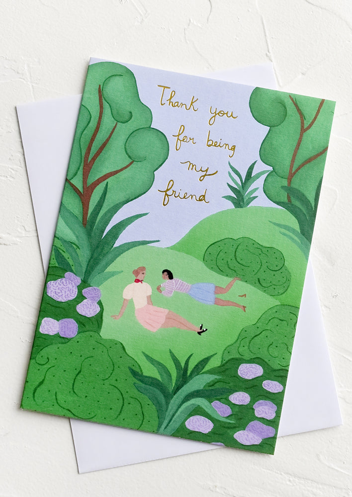 A greeting card picturing two women in a park with text reading "thank you for being my friend".