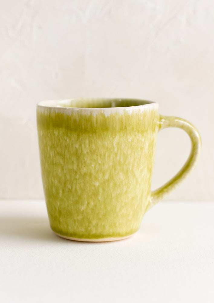 1: A glossy glazed chartreuse ceramic mug.