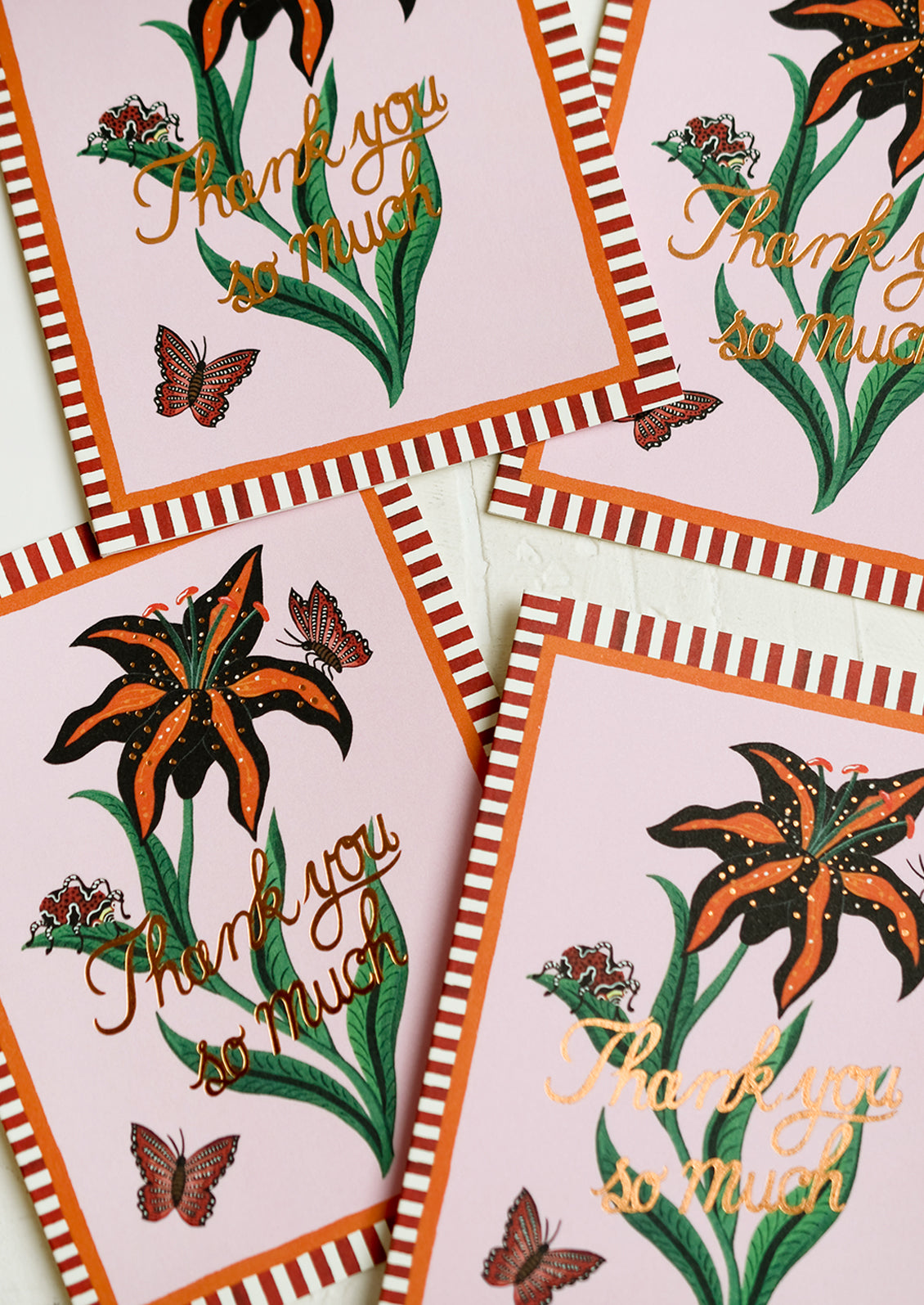 A tiger lily printed card set with striped border reading "Thank you so much".