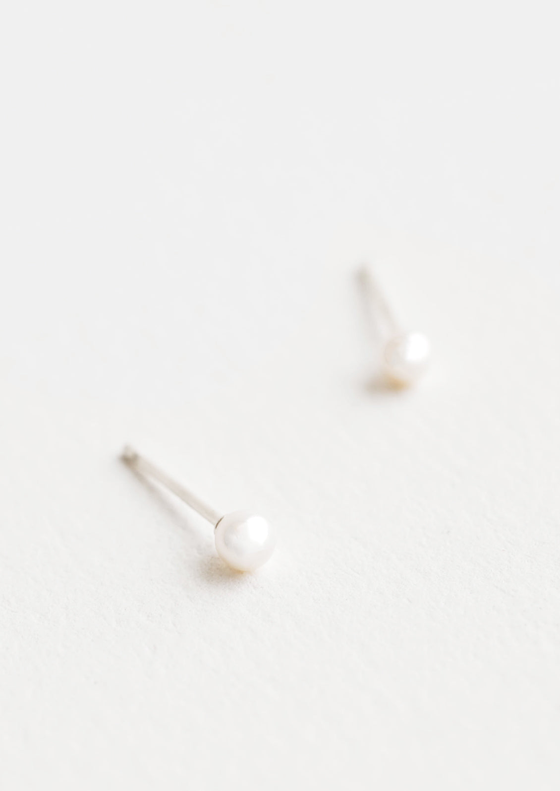 Tiny Pearl Stud Earrings in - LEIF