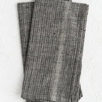 Slate Grey: A pair of charcoal fabric napkins with textured tonal stripe pattern.
