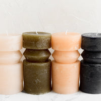 Medium (Ridge) / Olive: Assorted colors of geometric carved shape pillar candles.