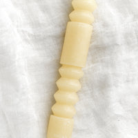 Vanilla: A geometric shape taper candle in vanilla (off white).