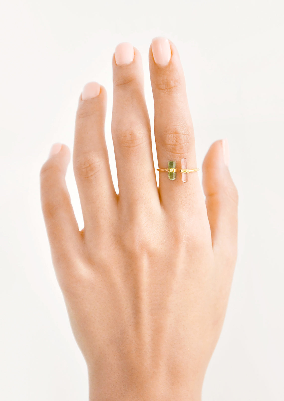 Model shot showing hand wearing ring with crystals.