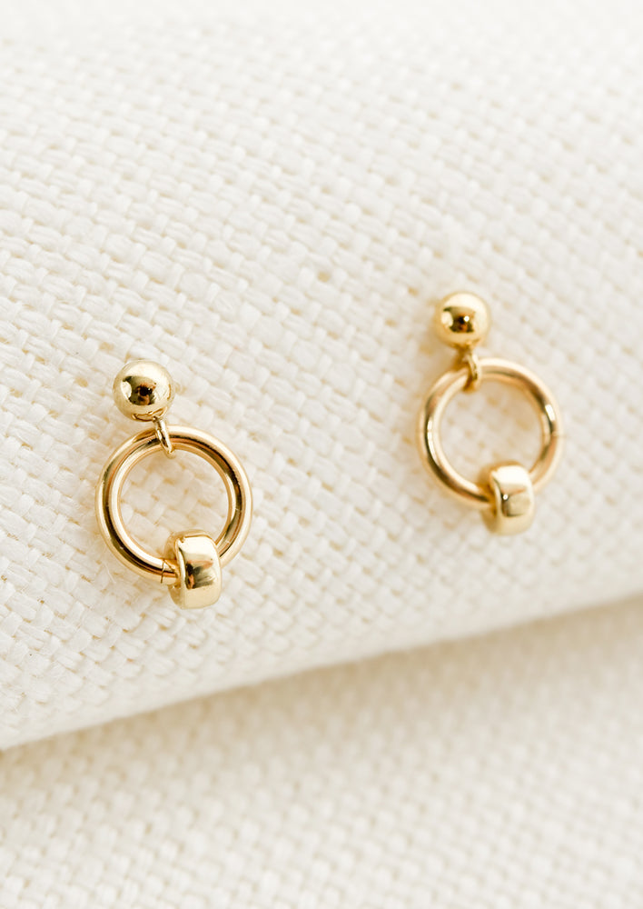 Circular gold studs with ball post and bead detail around circle.
