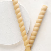 Ivory: Two twisted taper candles in ivory.