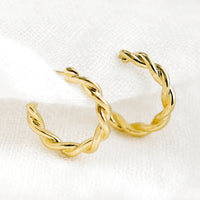1: A pair of gold twist hoop earrings.