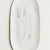 Carrots: An oval shaped ceramic serving platter with hand drawn carrots illustration at center.