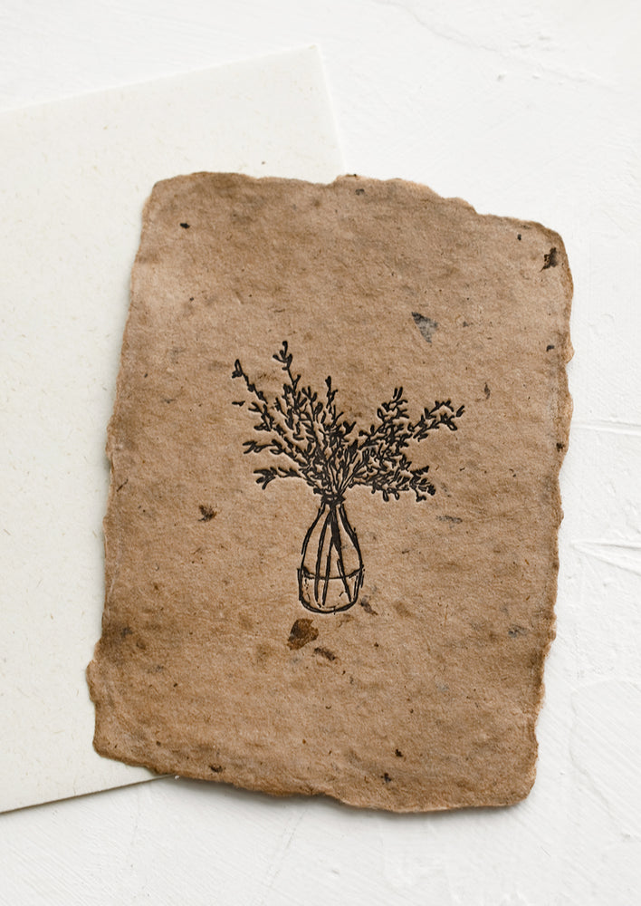 1: A handmade paper card with letterpressed image of vase with branches.
