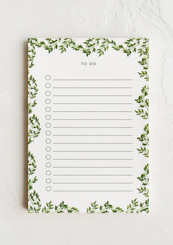 1: A ruled to do list notepad with vine print border.