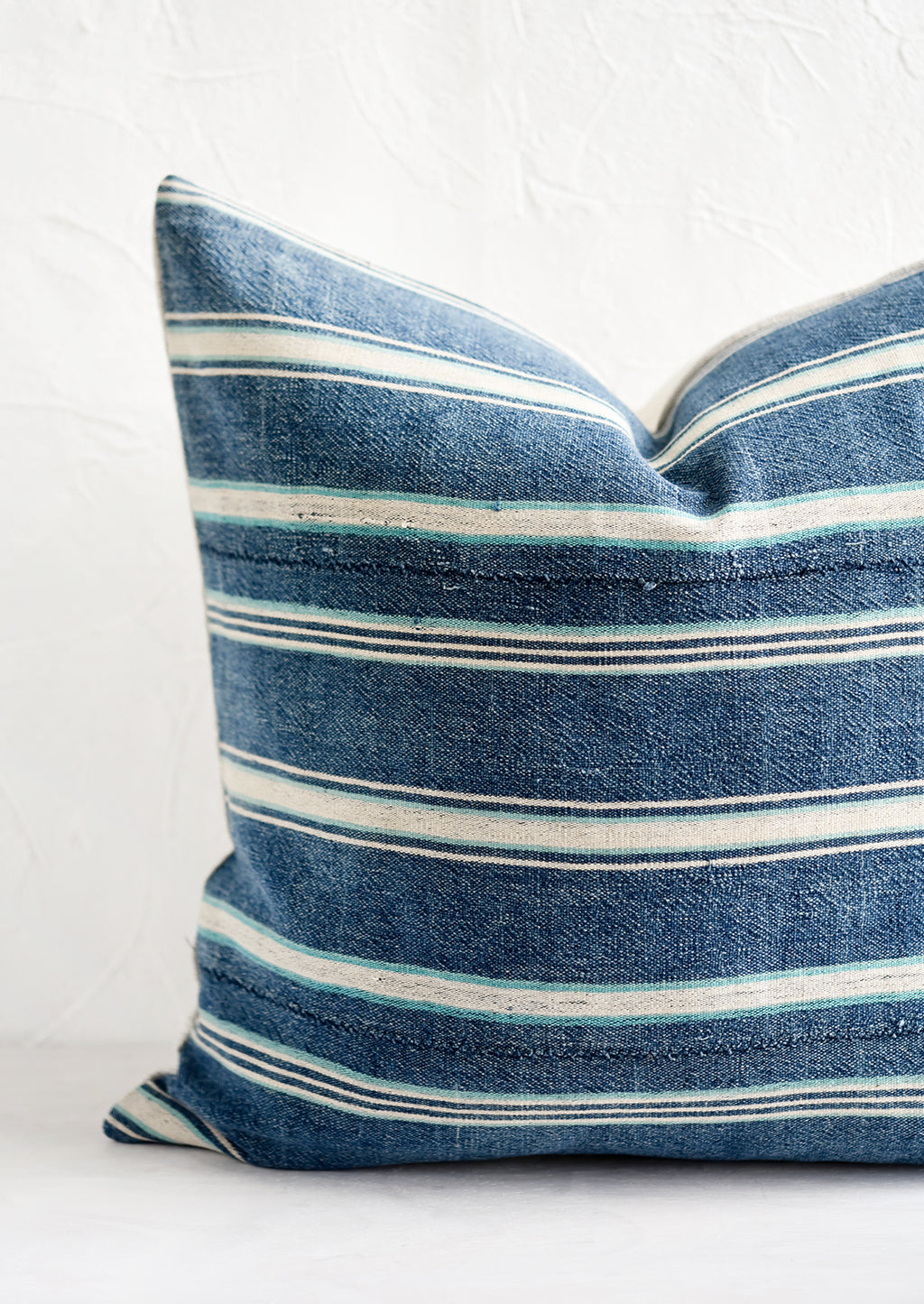 2: A square throw pillow in vintage indigo stripe fabric.
