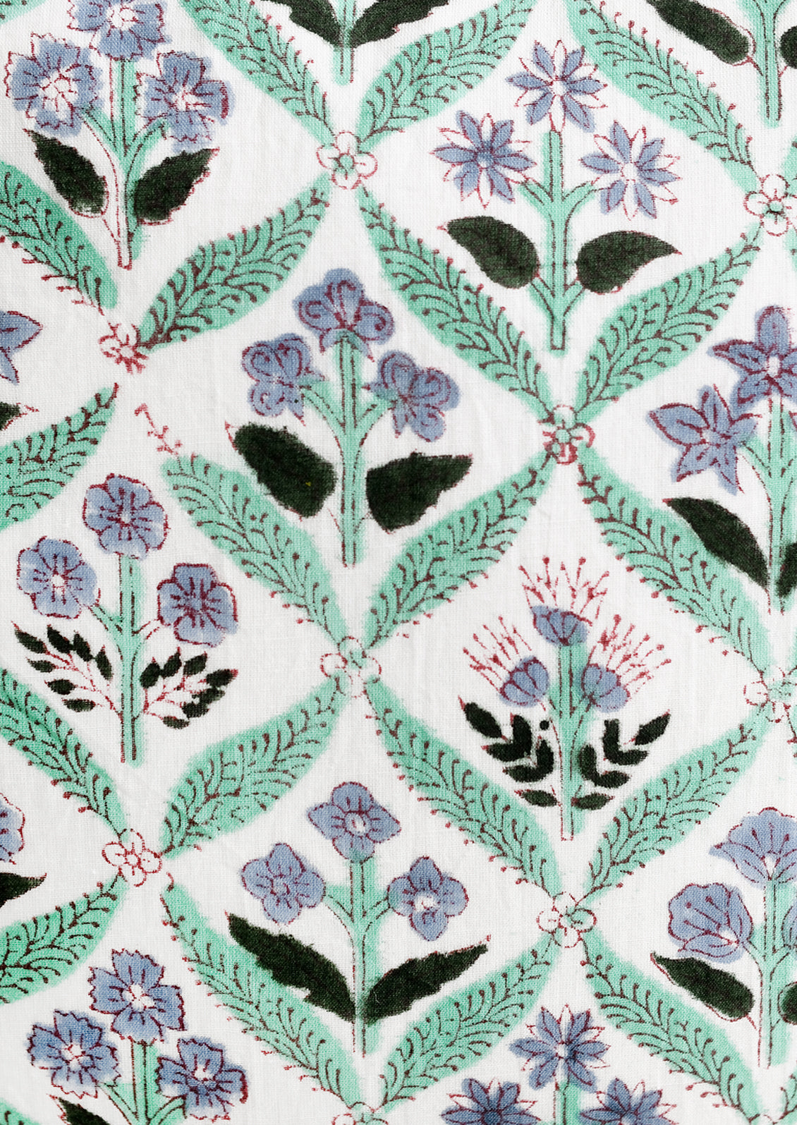 A block print pillow in mint and periwinkle botanical print.