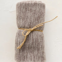 Taupe Melange: A knit cotton dish towel in taupe, rolled and tied with twine.