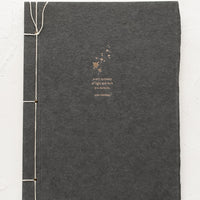 Walt Whitman: A journal with dark grey cover with Walt Whitman quote.