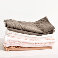 1: Stack of Cotton Napkins with frayed edges in browns and pinks.
