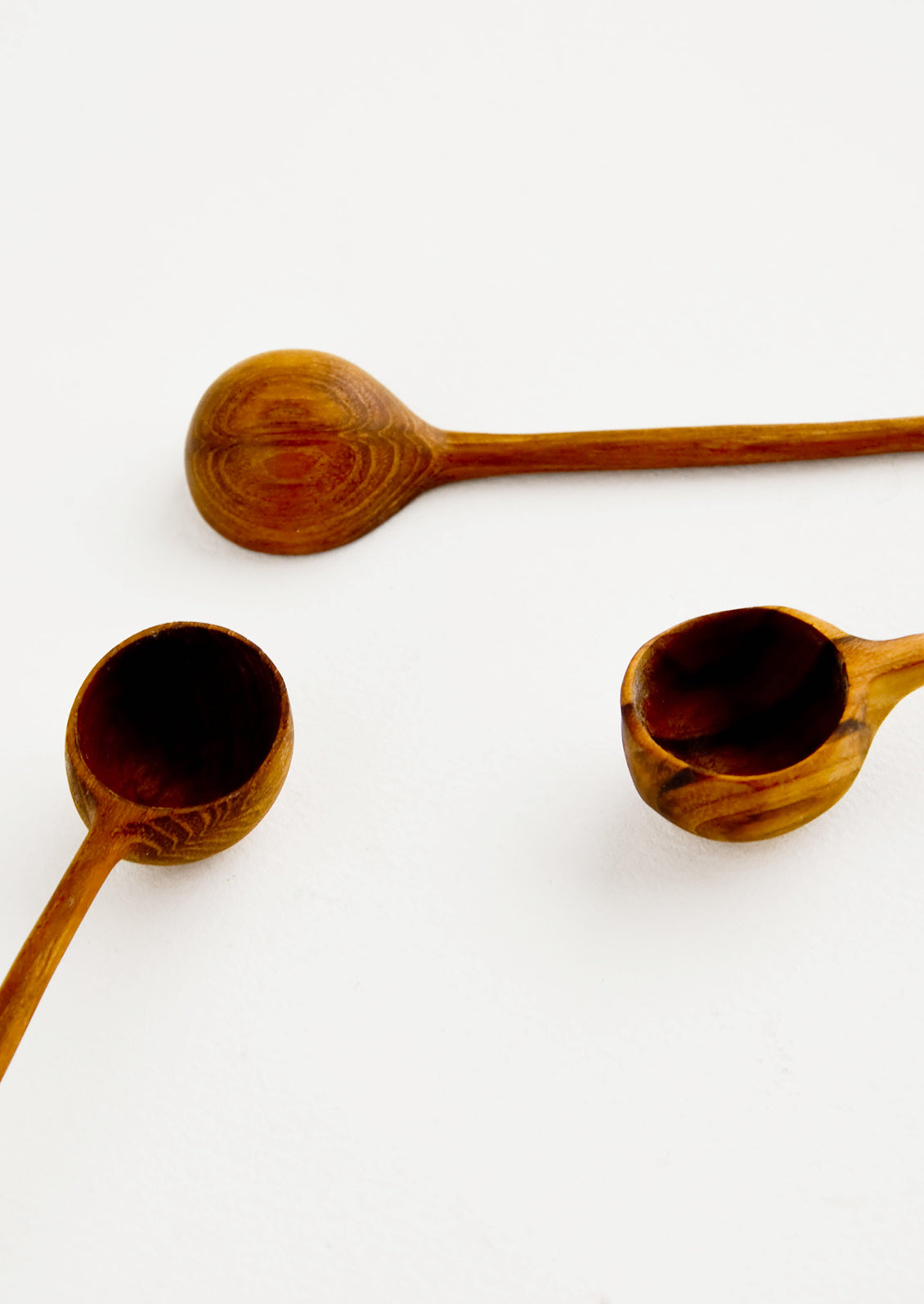 Detail of basins on hand carved wooden spoons