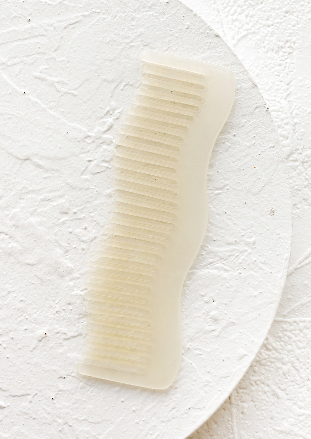 Ivory: A wavy shaped acetate comb in ivory.