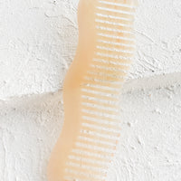 4: A wavy shaped acetate comb in peach.