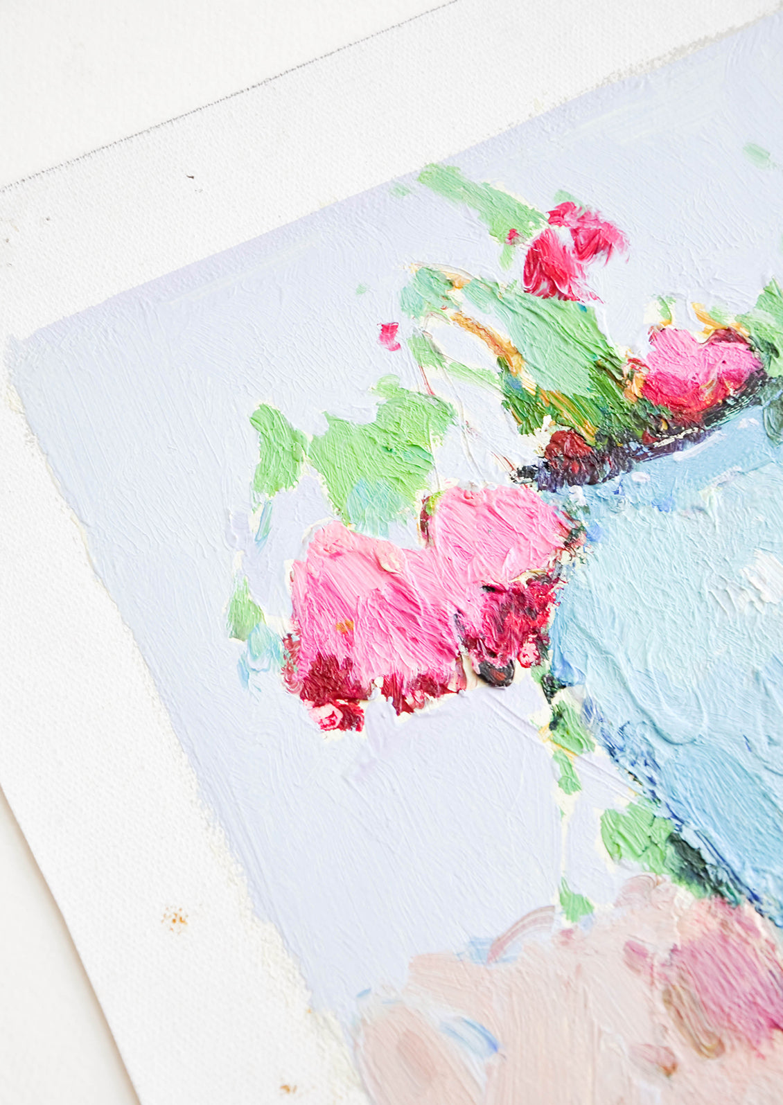 Close up of still life of pink flowers in blue vase.