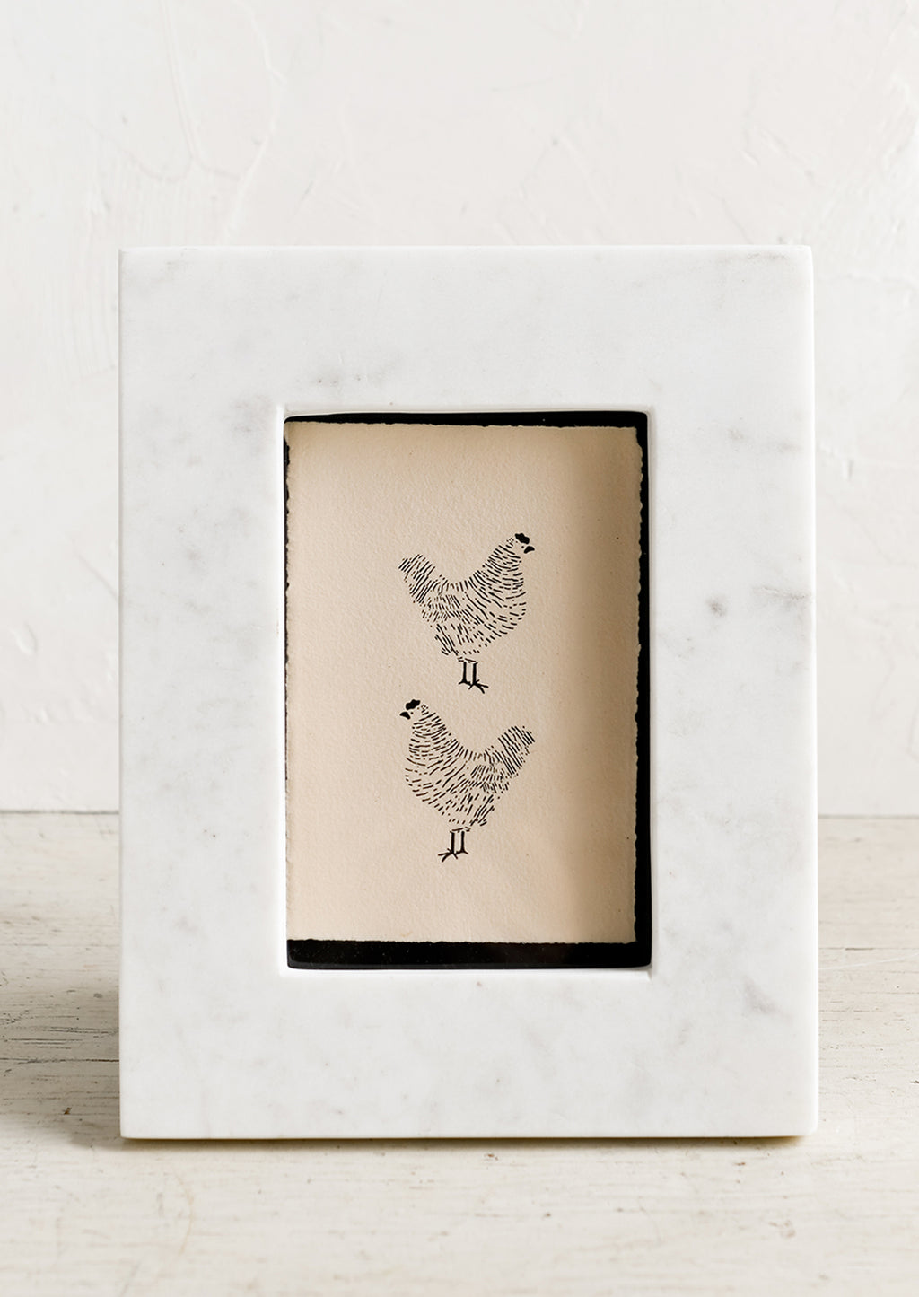 1: A white marble picture frame.