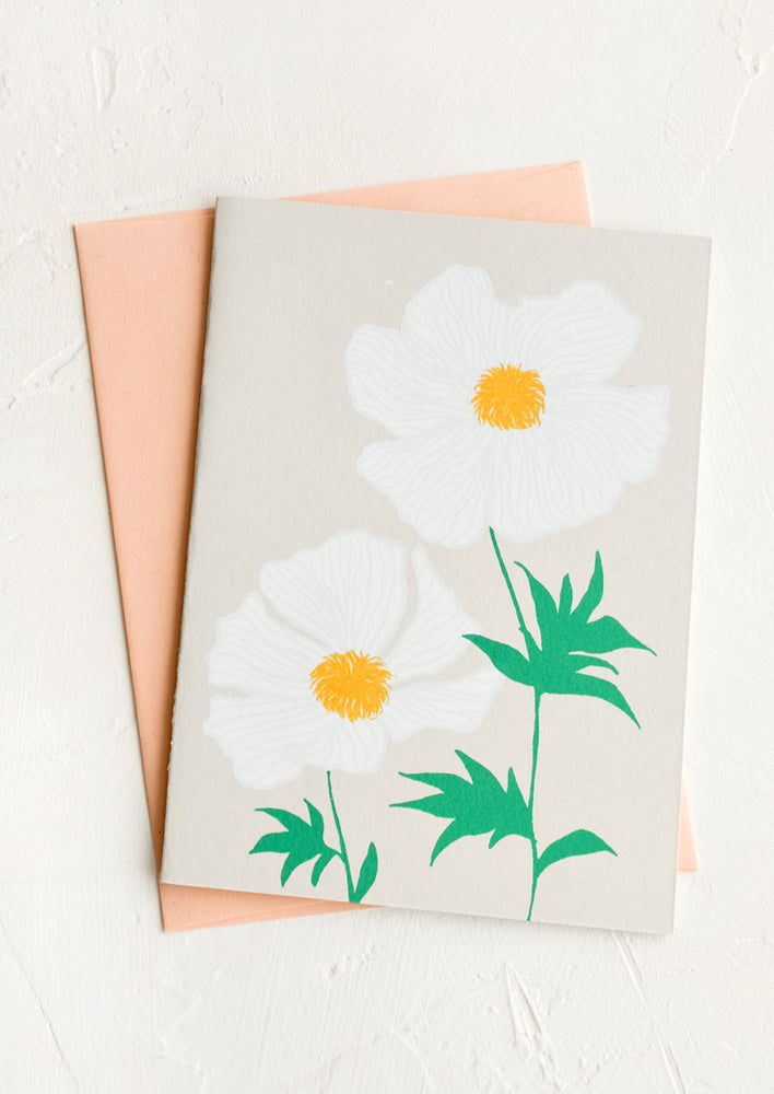 A greeting card with screen printed floral print and peach envelope.