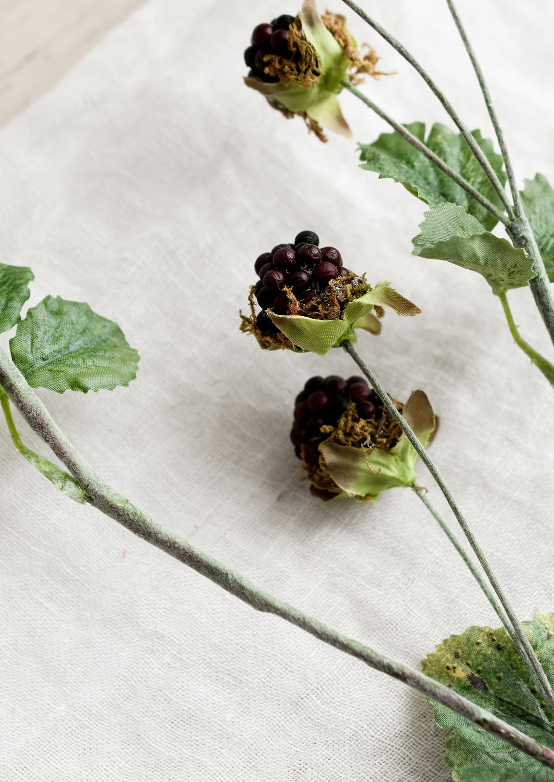 A decorative faux blackberry spray.