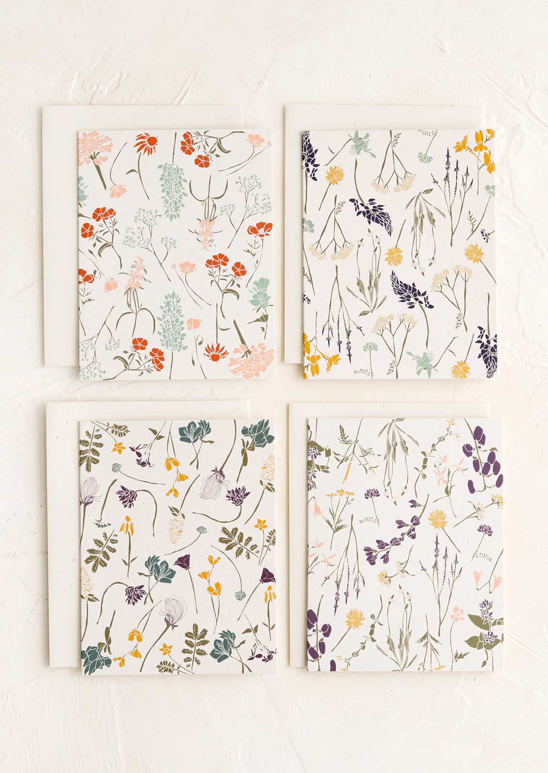 Four cards with wildflower patterns in slightly different designs and colors.
