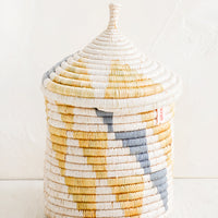 Medium [$68.00]: A medium woven basket with gourd-style lid in white with natural and slate grey triangle pattern.