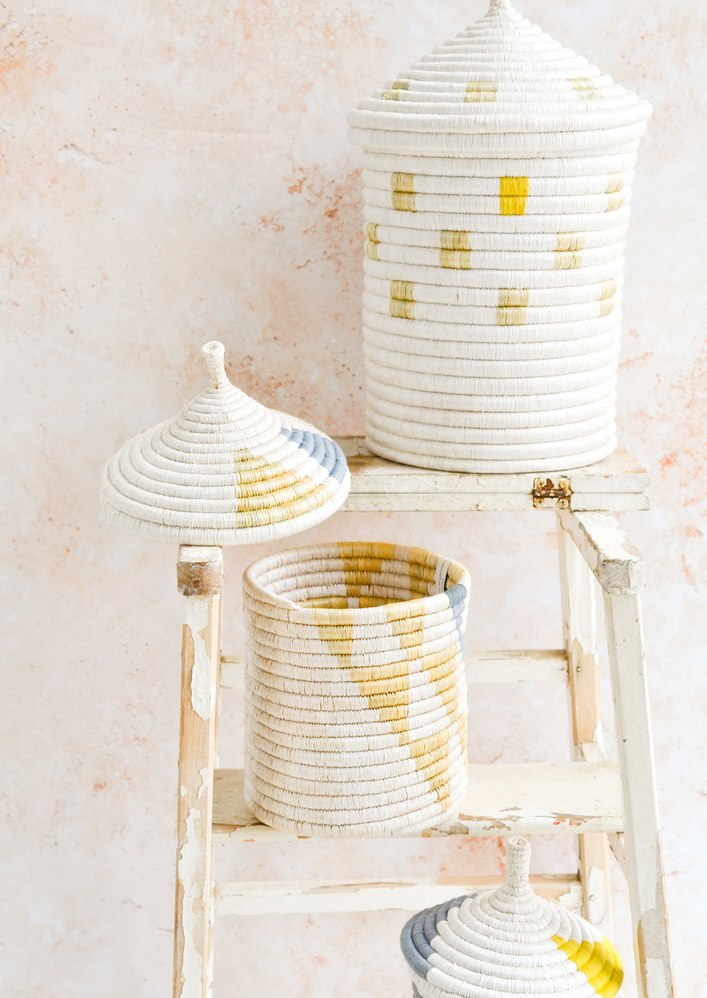2: Assorted woven lidded baskets in three incremental sizes.