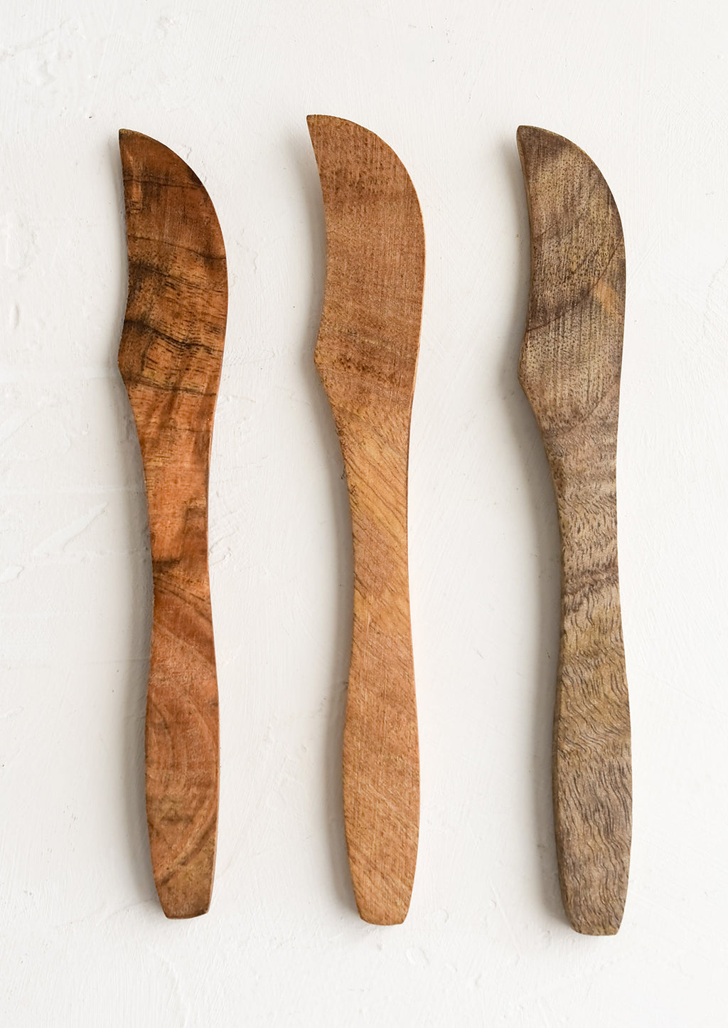 2: Wooden butter knives showing slightly varied wood colors.