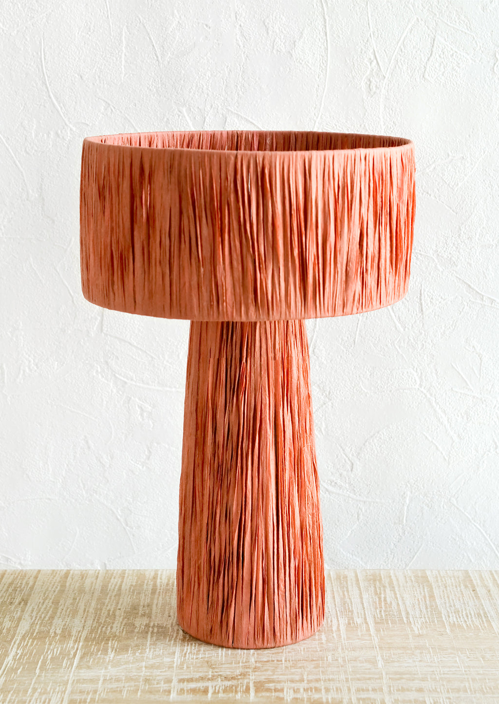 Terracotta Peach: A table lamp wrapped in peach raffia.