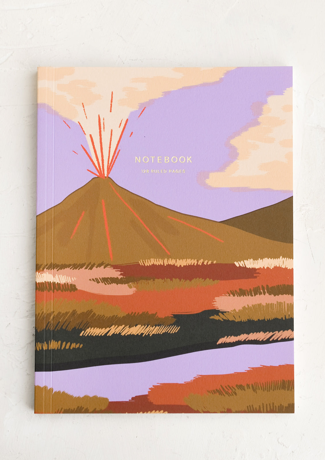A notebook with volcano graphic cover.