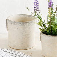 1: Two neutral ceramic planters in small and large sizes with lavender plant.