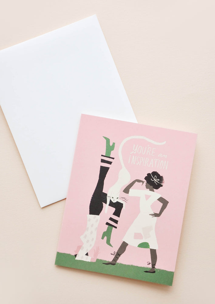 1: A white envelope and a pink greeting card depicting two women and a cat with the words "you're an inspiration."