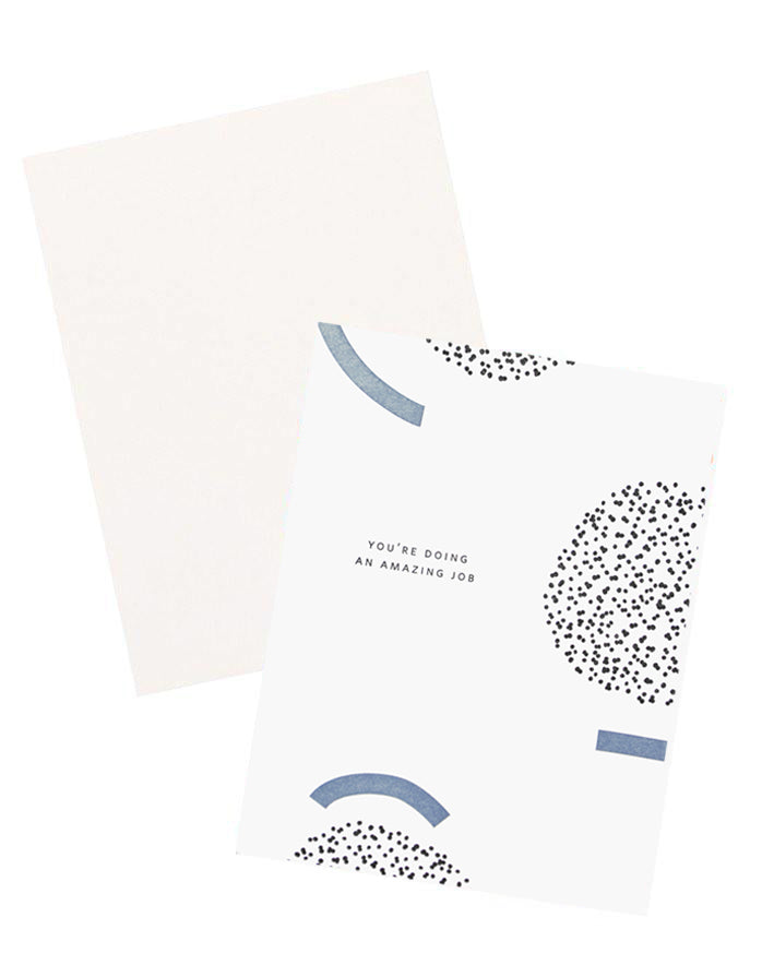 White notecard with black and blue geometric decoration and the text "You're doing an amazing job", with white envelope.