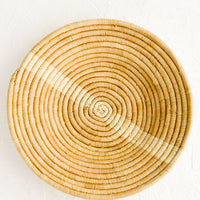 Tan / Natural: Tan woven raffia bowl with natural streak across middle