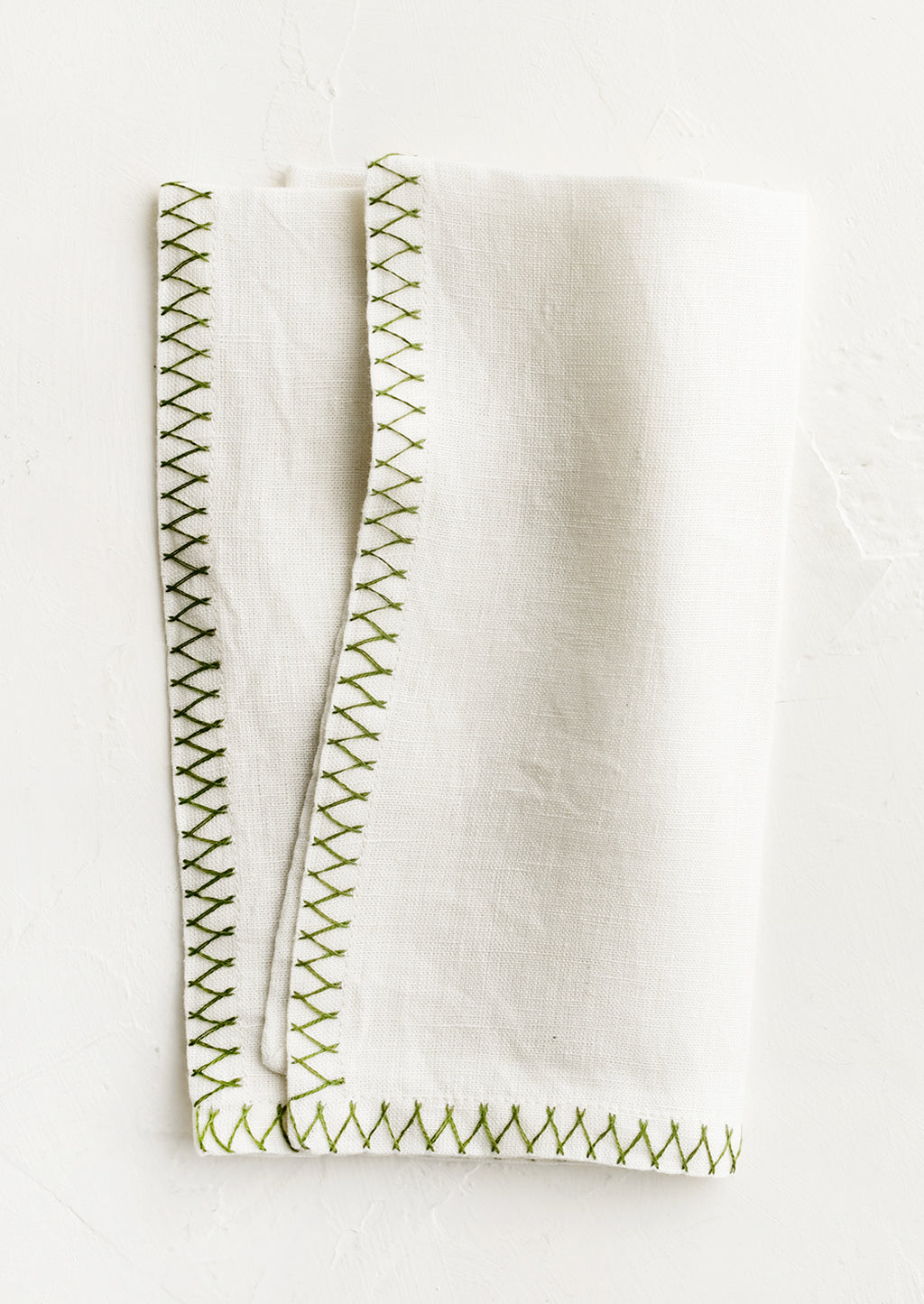 Fern Green: A white linen napkin with green embroidered zig zag border.