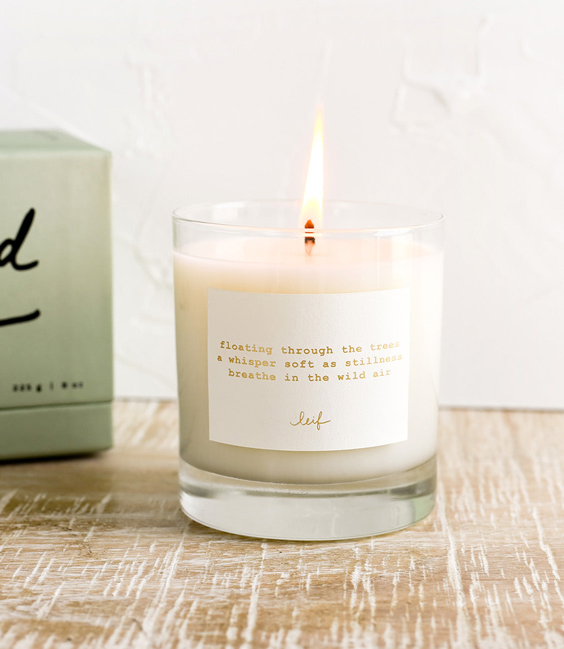 A jar candle with haiku print label.