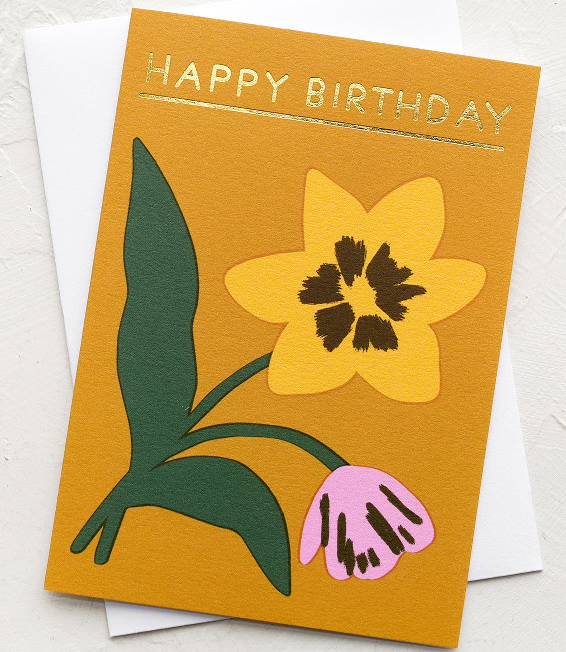 A mustard card with daffodil and tulip drawing, text at top reads "Happy Birthday".
