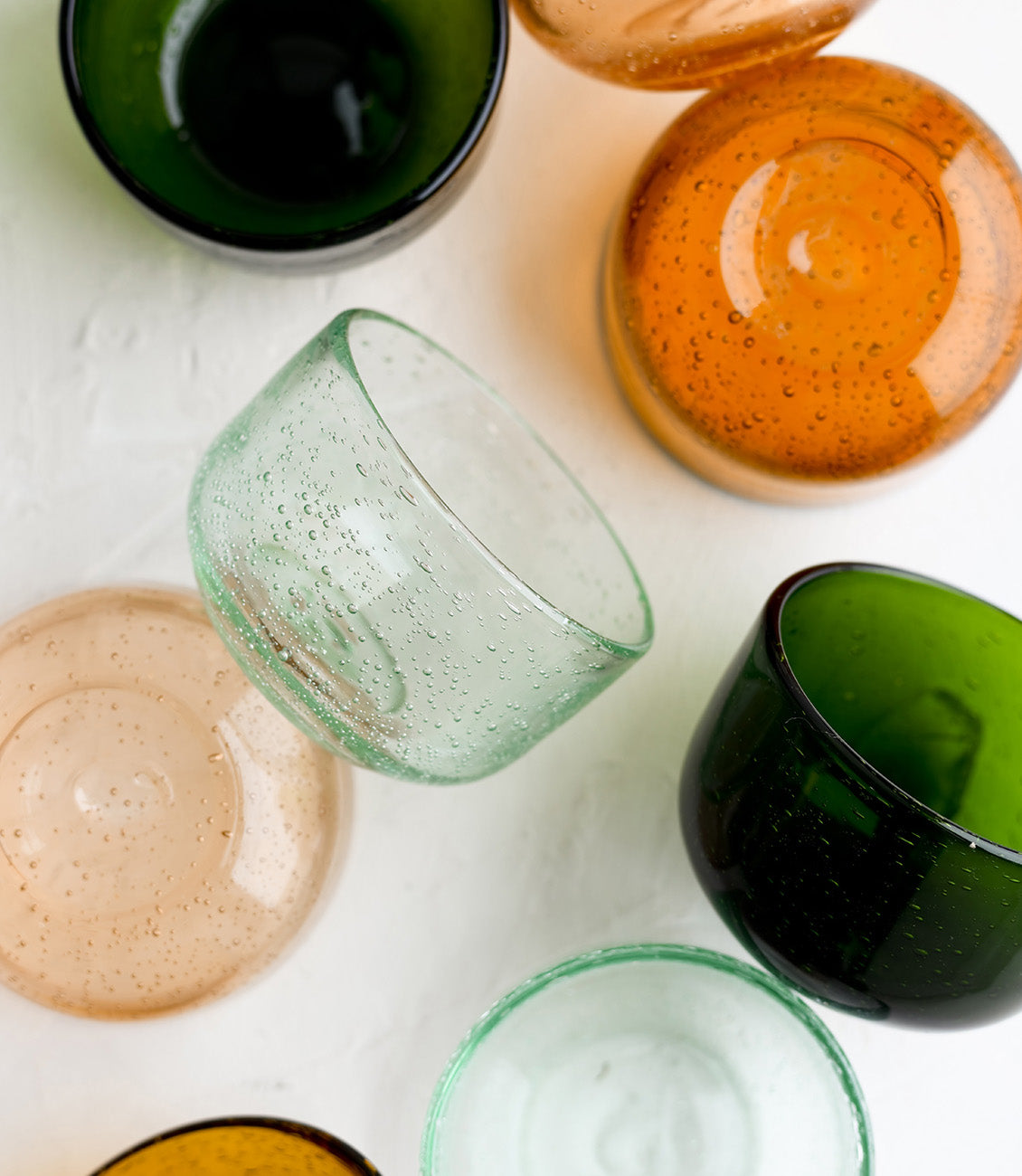 Small tinted glass bowls in assorted colors.