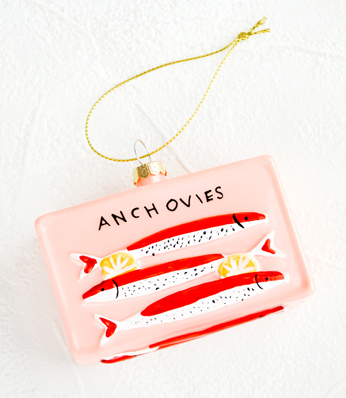 A holiday ornament in the shape of a tin of anchovies.