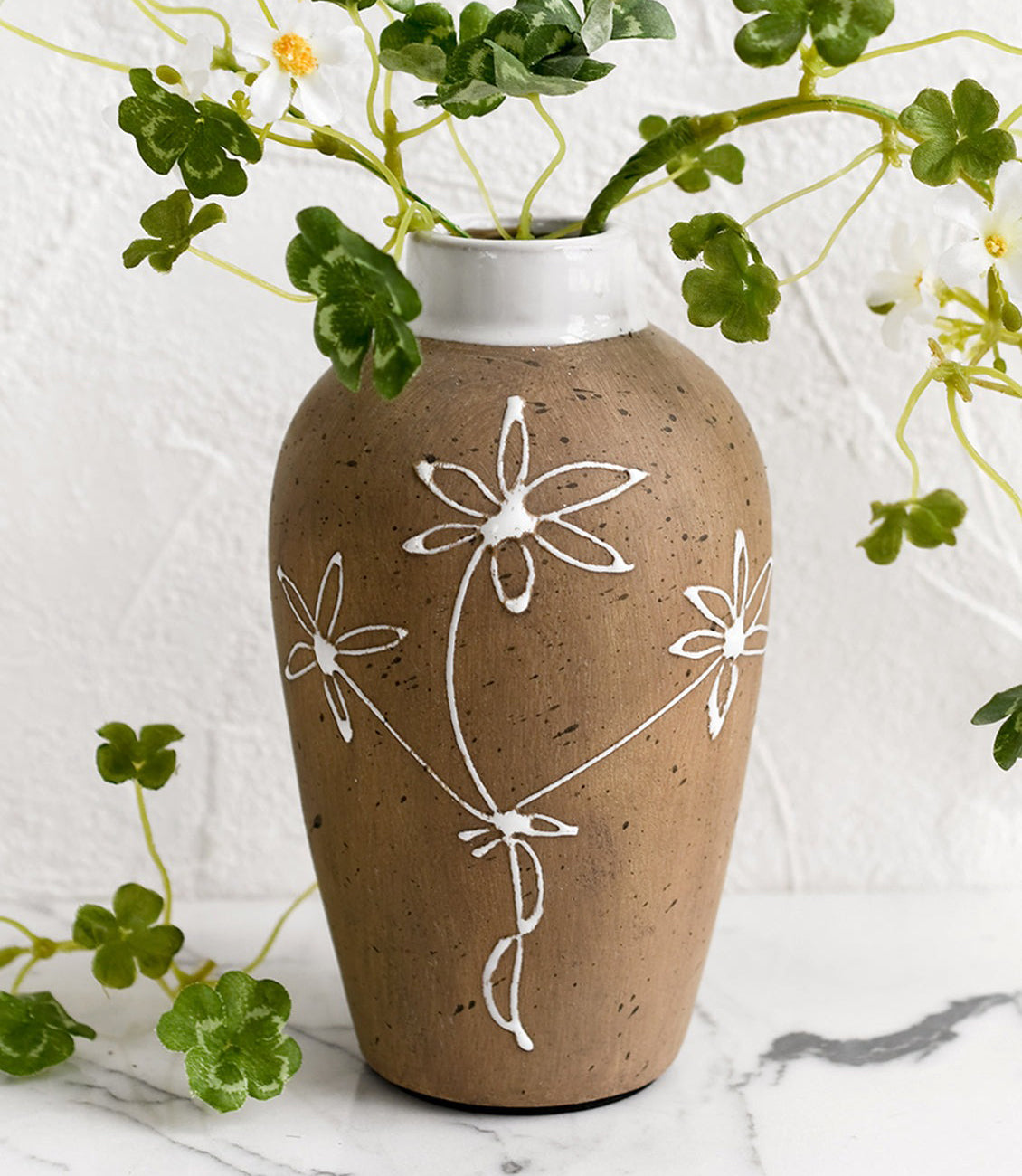 A ceramic vase with painted floral pattern.