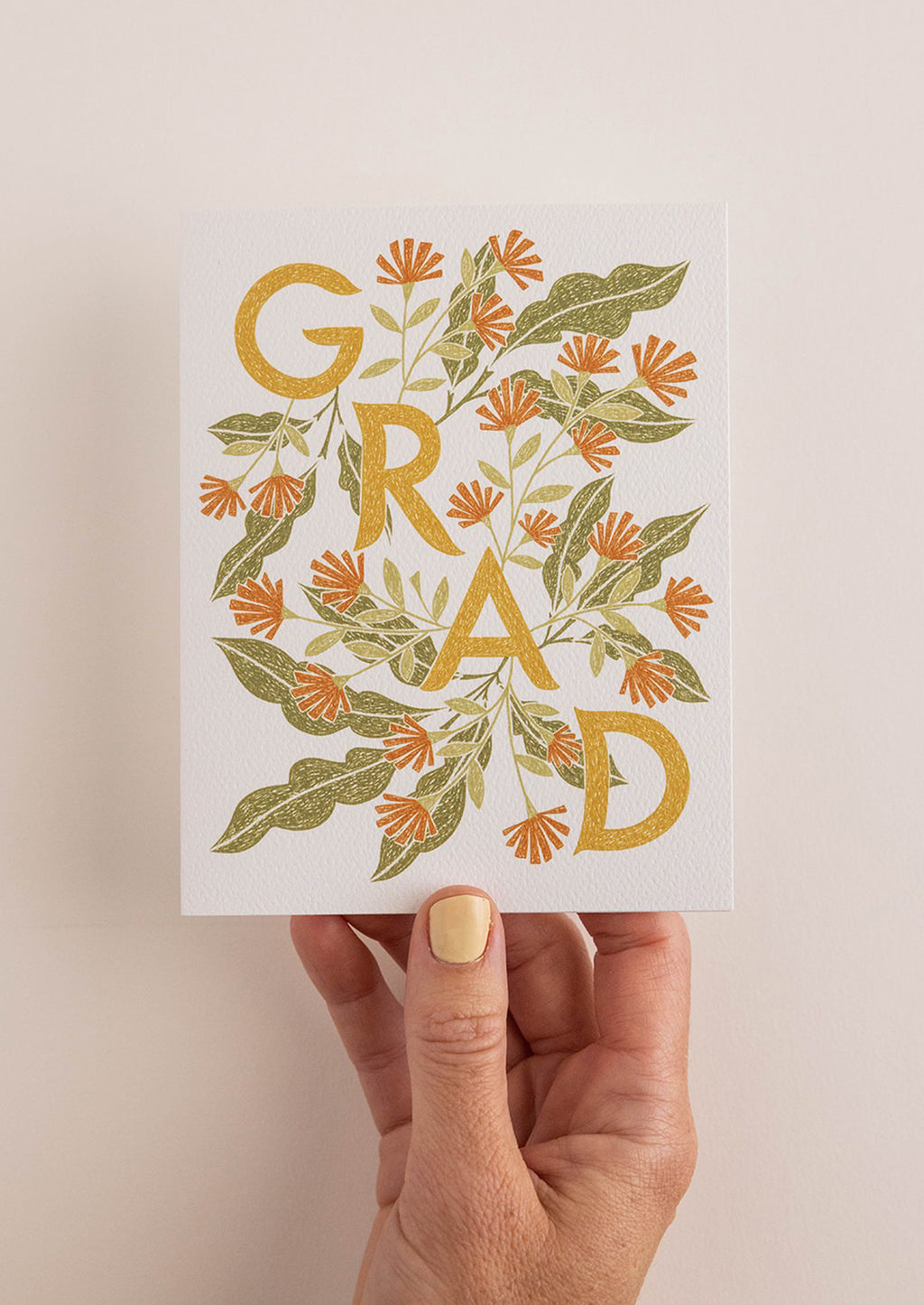 2: A floral print card reading "GRAD".