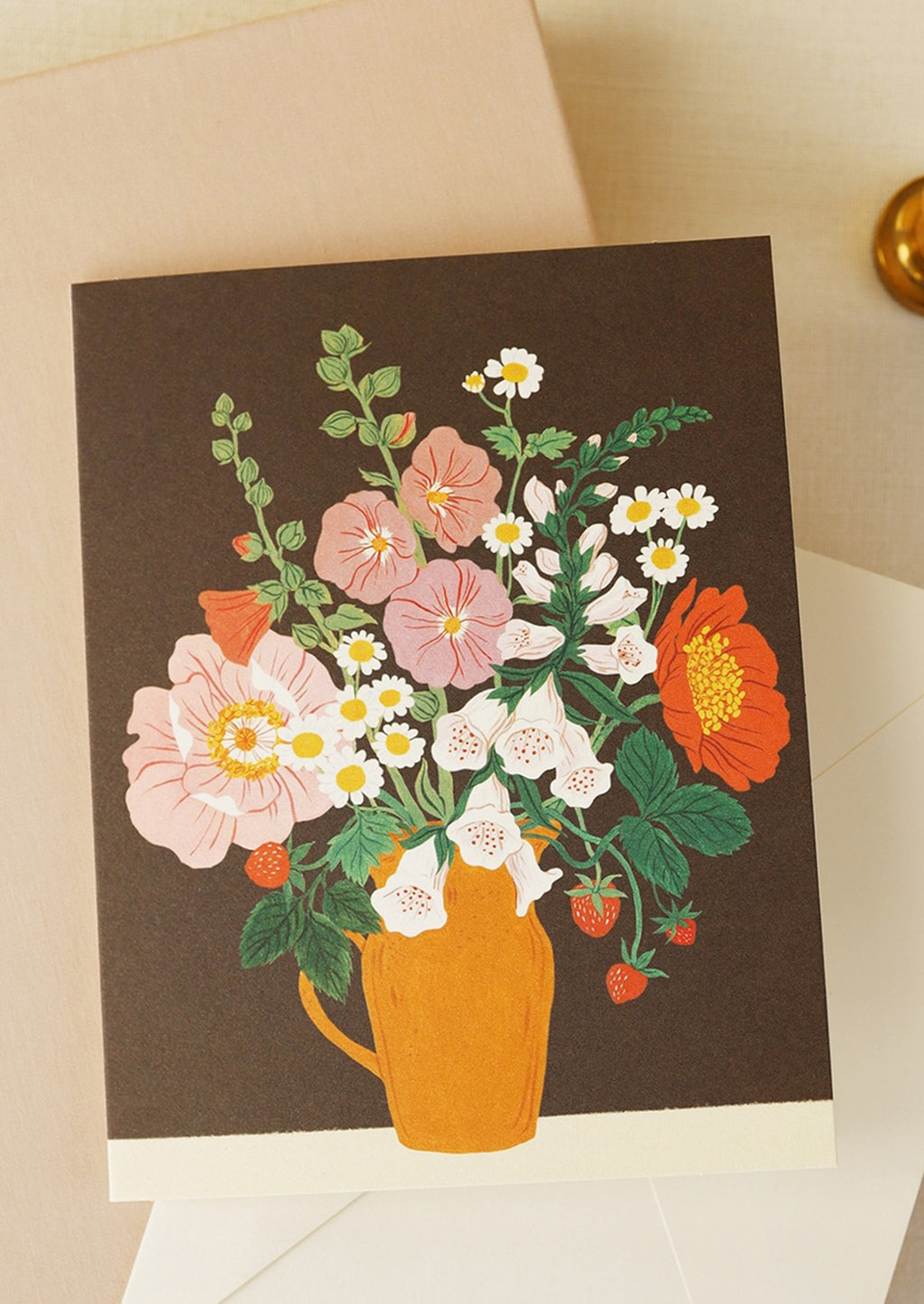 2: A greeting card with floral arrangement on brown background.