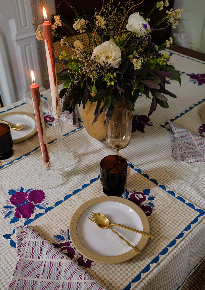 2: A block printed placemat in wine, blue and beige color palette.