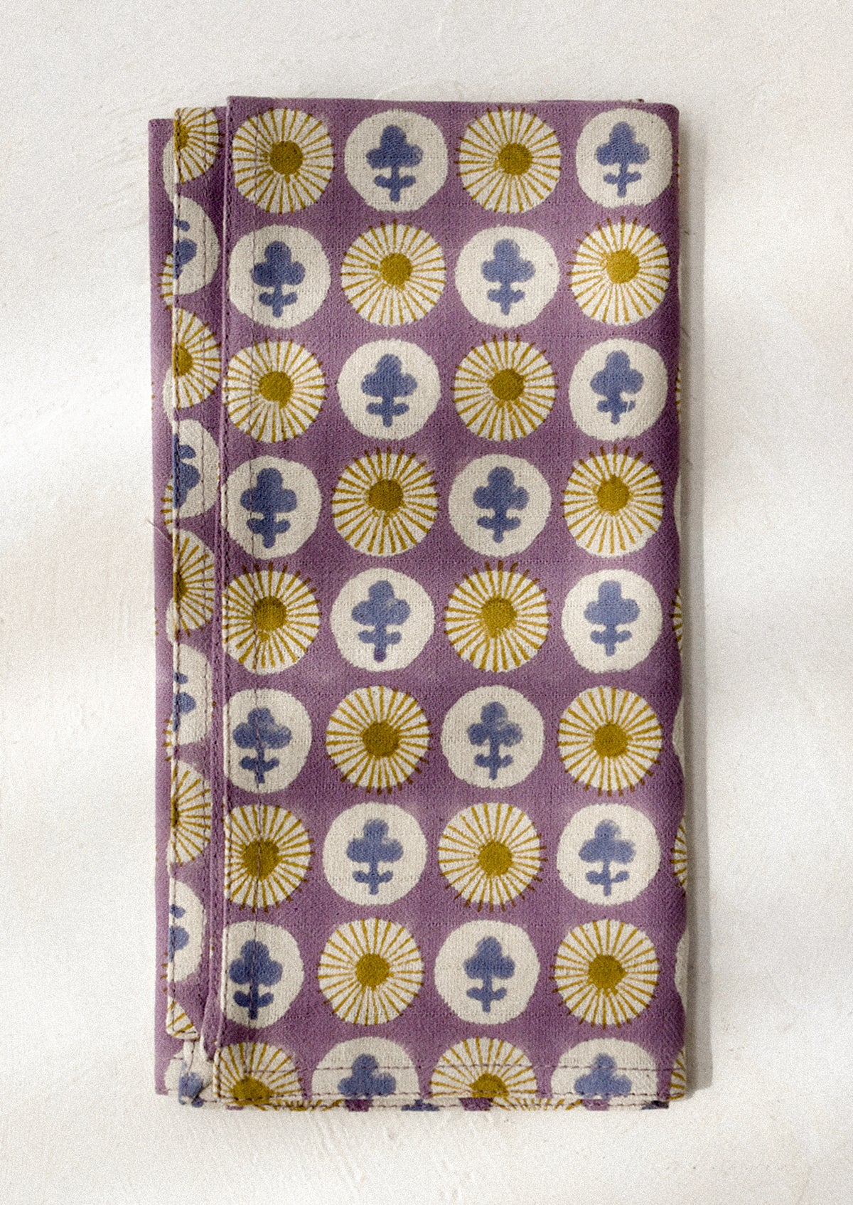 Purple dinner napkin with floral pattern on a white background