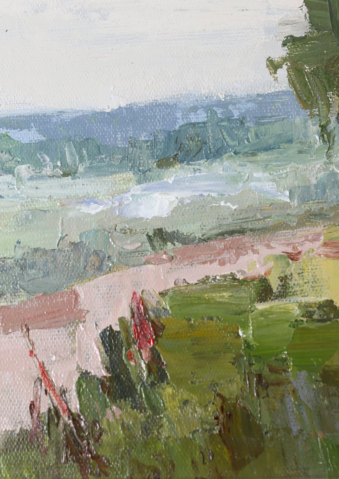 An impressionistic landscape painting showing a green field with a pink path, distant blue hills, and a pale sky, rendered with visible textured brushstrokes.